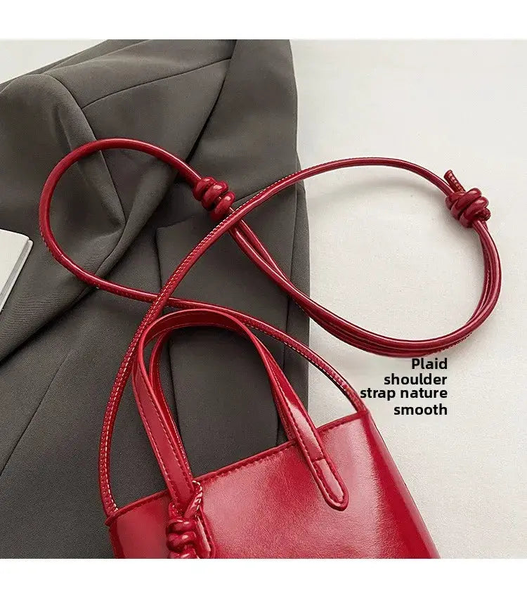 PU leather mini crossbody bag; red with top handles and long shoulder strap, retro style.