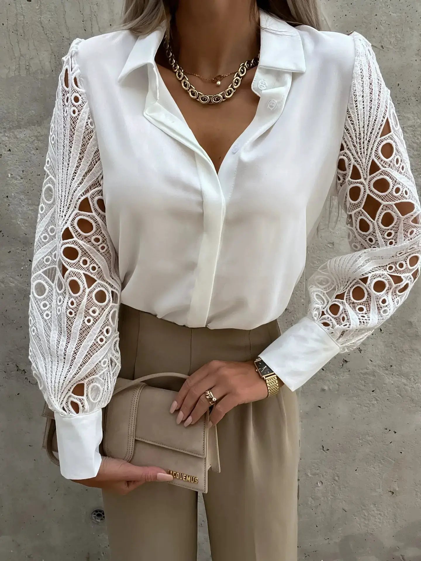 White chiffon blouse with intricate lace sleeves and a V-neck.