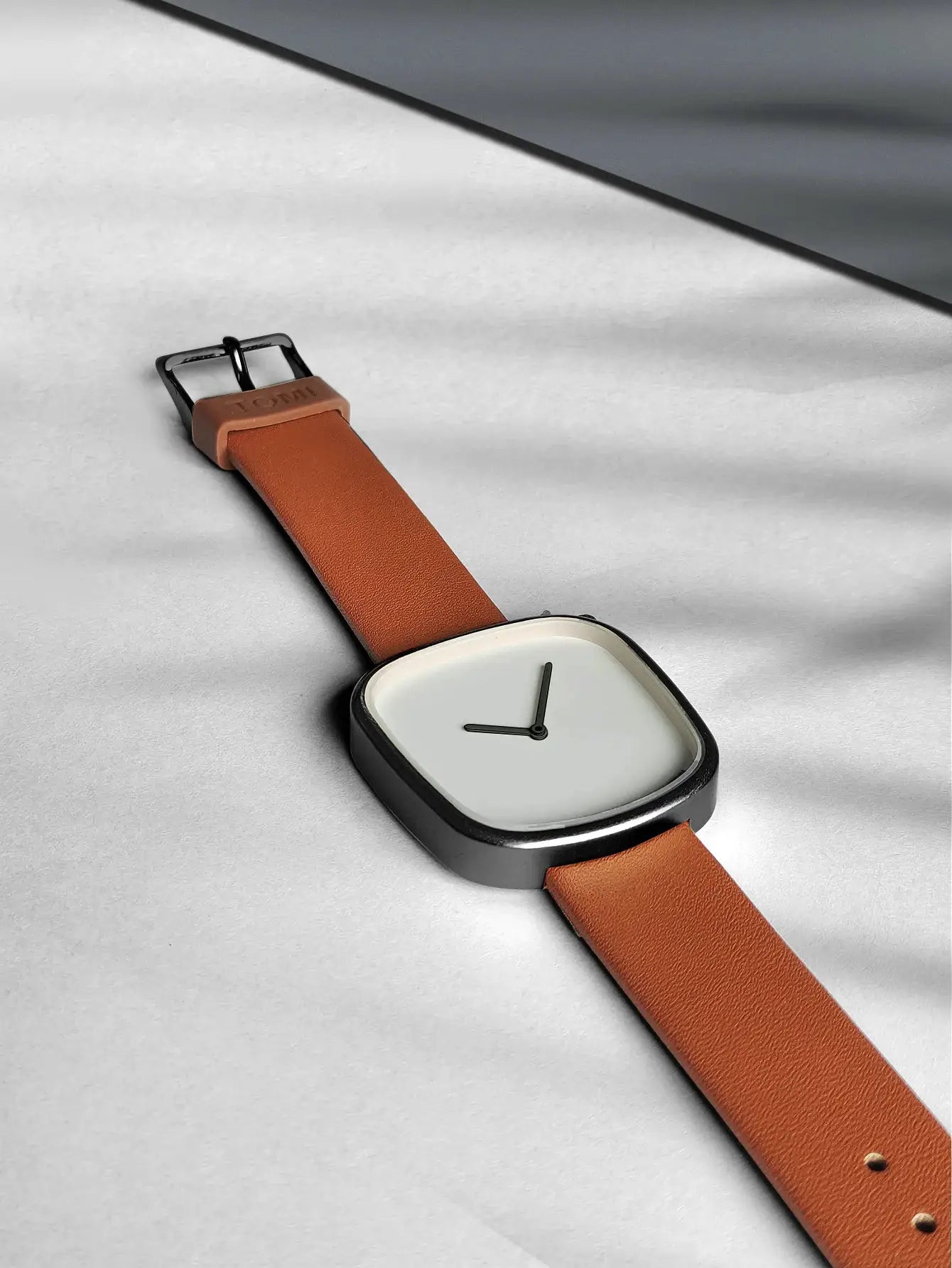 TOMI watch; minimalist square design with tan leather strap, black bezel, white dial