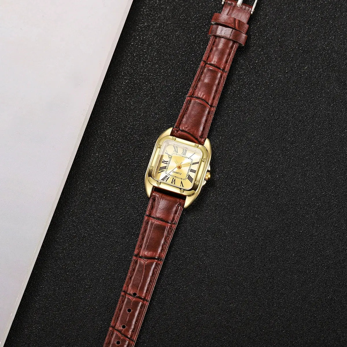 Women's gold-tone square-faced watch with brown leather strap and Roman numeral dial