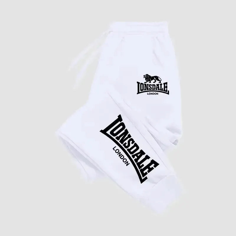 White Lonsdale joggers with London logo on hip and bold leg print, men's athletic sweatpants.