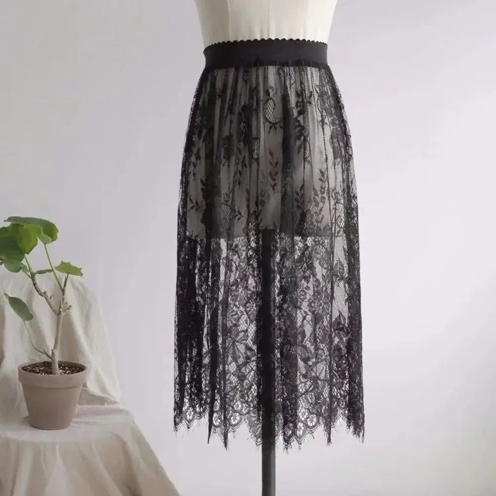Women's black lace half slip with high-waist band and sheer floral overlay.