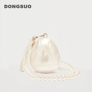 Egg-shaped pearl clutch bag with beaded strap in ivory, by DONGSUO