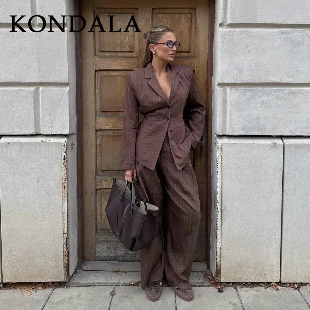 KONDALA striped brown office suit with a tailored blazer and wide-leg pants, paired with a dark tote bag