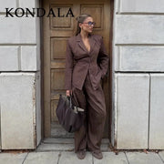 KONDALA striped brown office suit with a tailored blazer and wide-leg pants, paired with a dark tote bag