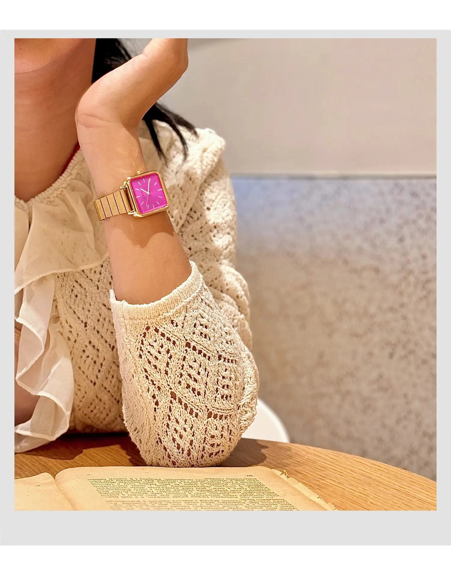 Simples Market gold-tone stainless steel women's watch with pink square dial worn on the wrist.