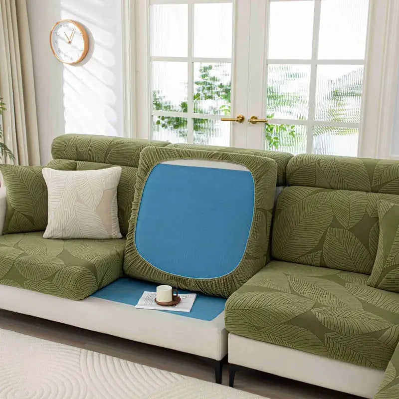 New thick plush sofa cover with elastic edges in olive-green leaf-pattern fabric to protect living room furniture