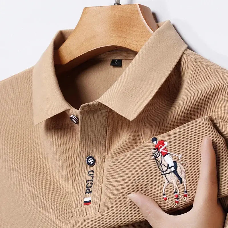 Beige men's polo shirt with embroidered polo horse logo on chest and small flag patch