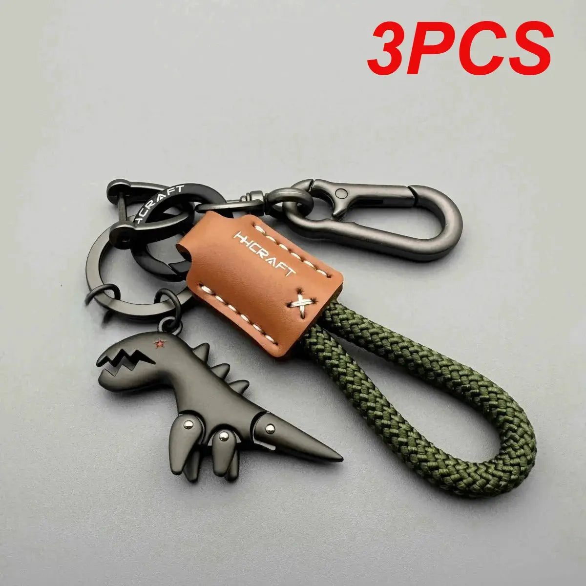 Motorcycle-themed keychain set with brown leather tag, green braided rope, and dinosaur charm (3 pcs)