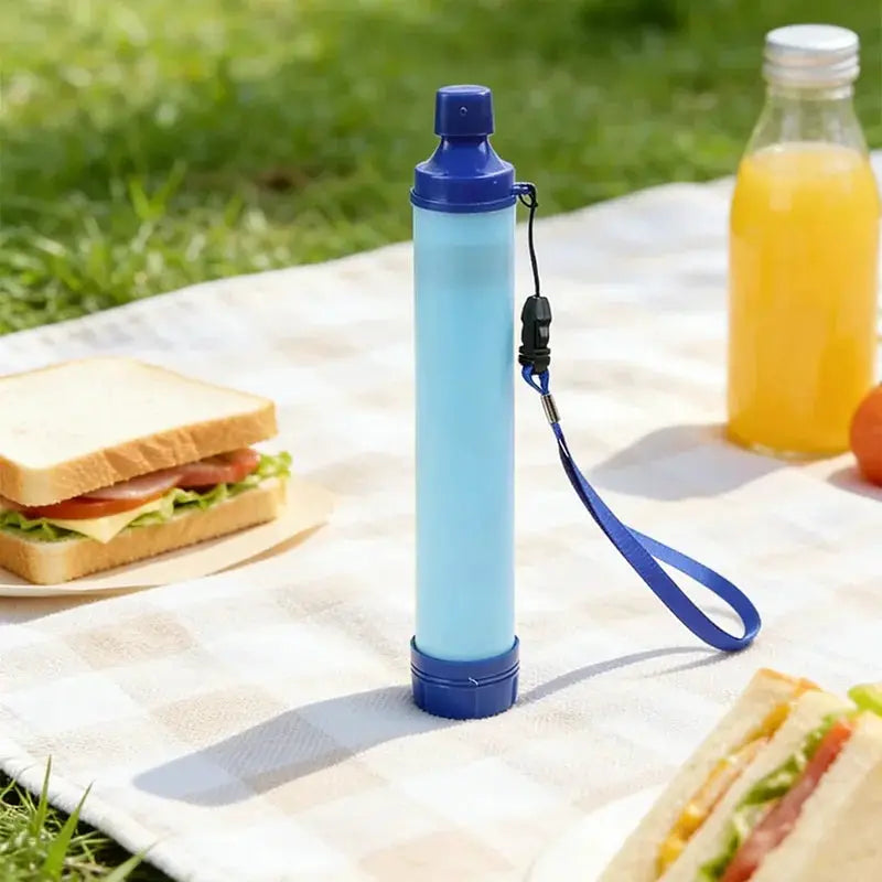 Portable emergency water filter straw by Simples Market; blue cylindrical purifier with strap for camping and hiking.