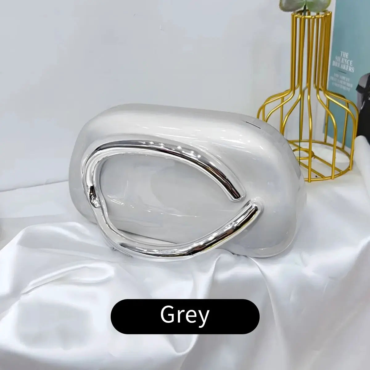Grey acrylic box crossbody bag with curved silver handle for elegant evening events by Simples Market