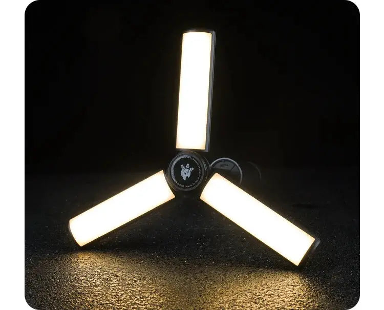Rechargeable outdoor camping light by Simples Market with three foldable LED panels and hub, warm white floodlight.