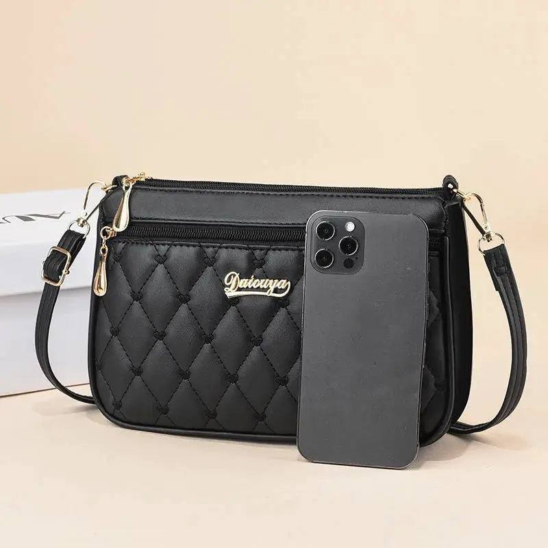 Crossbody bag by Simples Market in black PU leather with quilted pattern and detachable strap