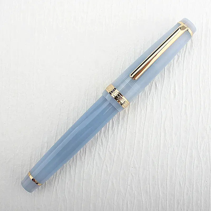 Jinhao 82 fountain pen in blue acrylic with gold trim and converter