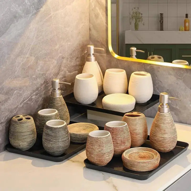 Ceramic bathroom accessories set with ribbed, earth-toned dispensers, cups, and trays