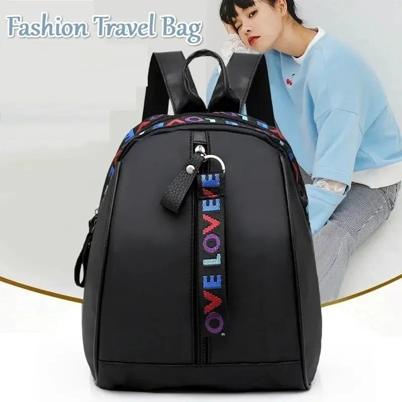 Women's black backpack with colorful LOVE strap accent for casual school use
