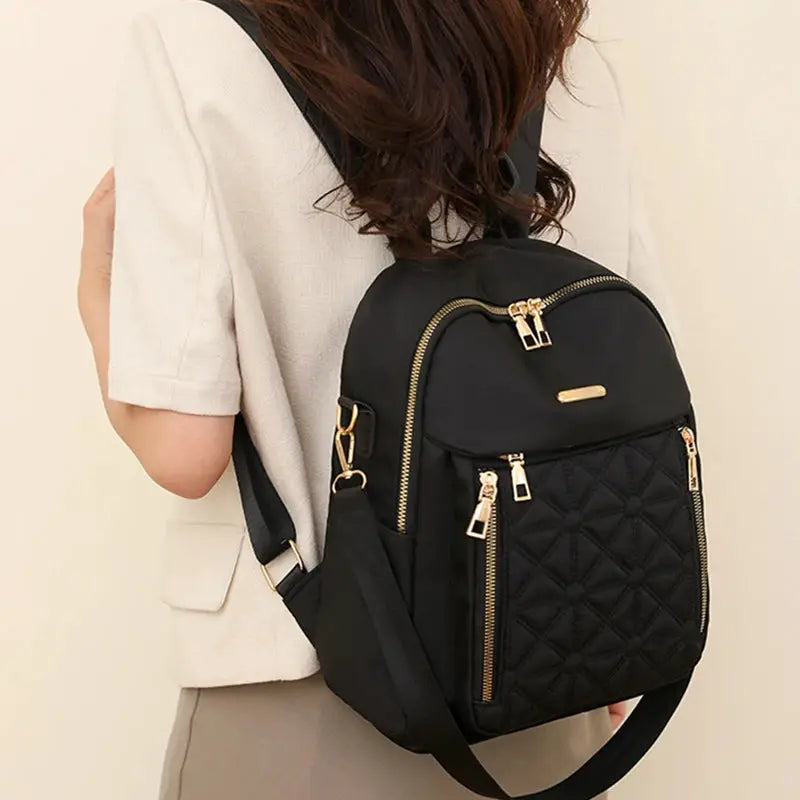 Simples Market nylon backpack for women, black with gold zippers, quilted front pocket and multiple compartments