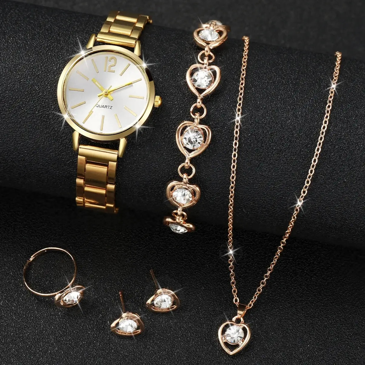 Gold-tone 6-piece women's jewelry set featuring quartz watch, crystal heart bracelet, necklace, ring, and stud earrings