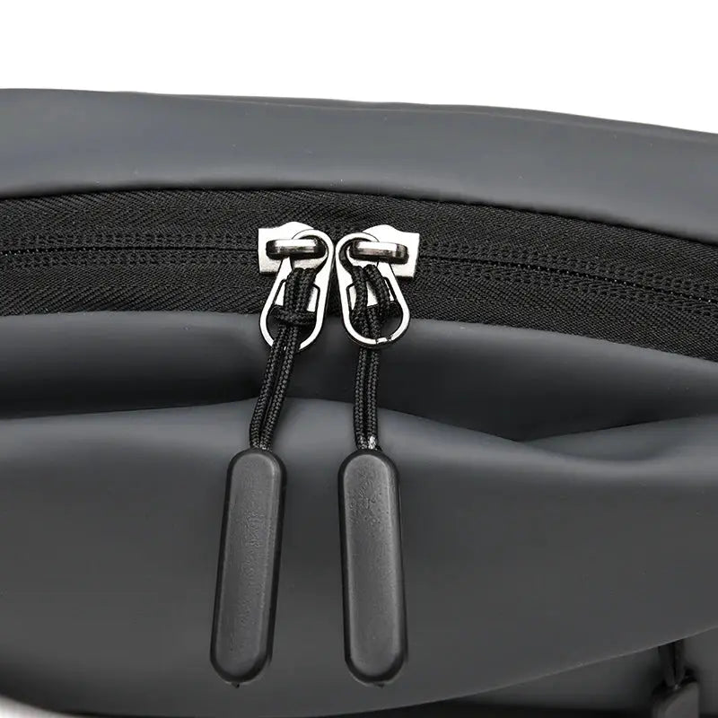 Men's waterproof waist bag with dual zippers and cord pulls, black minimalist fanny pack
