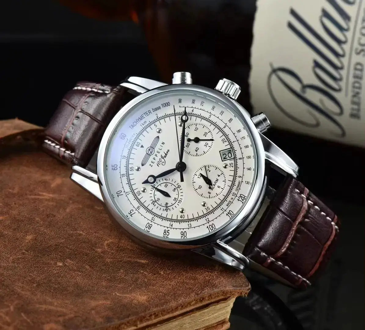 Zeppelin 2026 Airship commemorative men's automatic watch; silver case, white chronograph dial, brown leather strap.