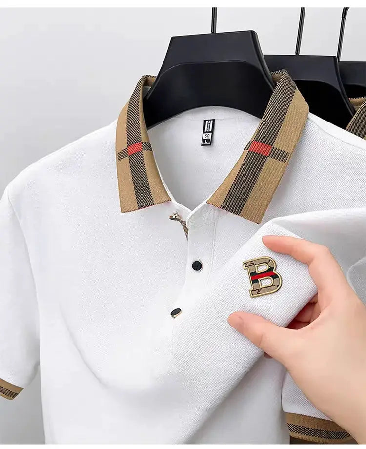 Three men's white polo shirts with beige plaid collars and gold B logo patches