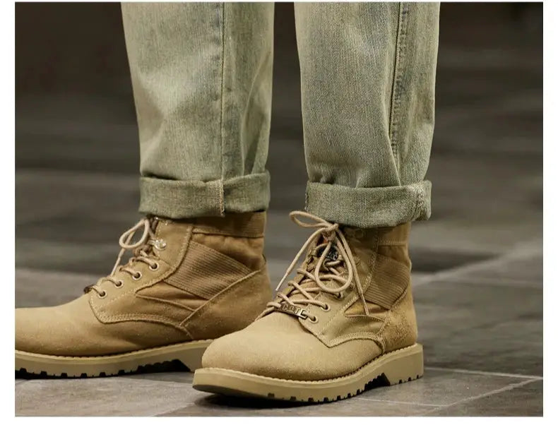 Men's tan suede lace-up boots with rugged soles, paired with rolled light denim jeans