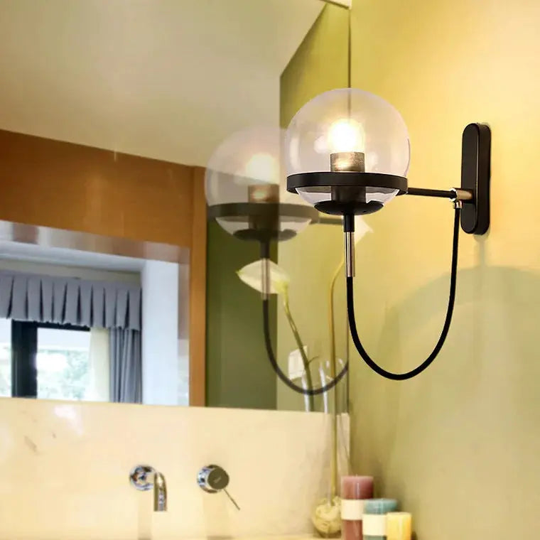 Modern glass ball wall lamp with black metal arm and wall mount
