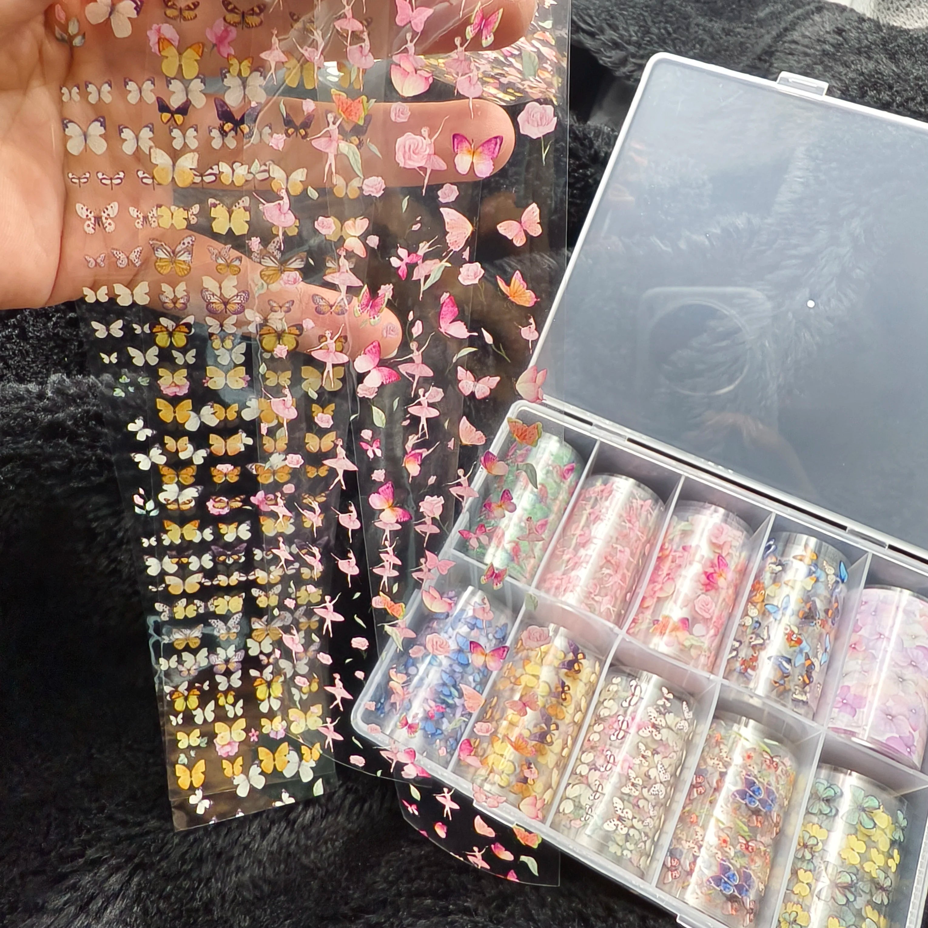 Nail art decals from Simples Market: butterfly and floral foil stickers on clear sheets, pink/yellow hues
