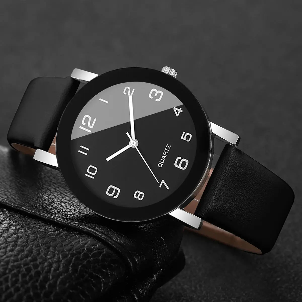 Couple's leather strap wristwatch with black dial and silver case; white Arabic numerals, quartz movement