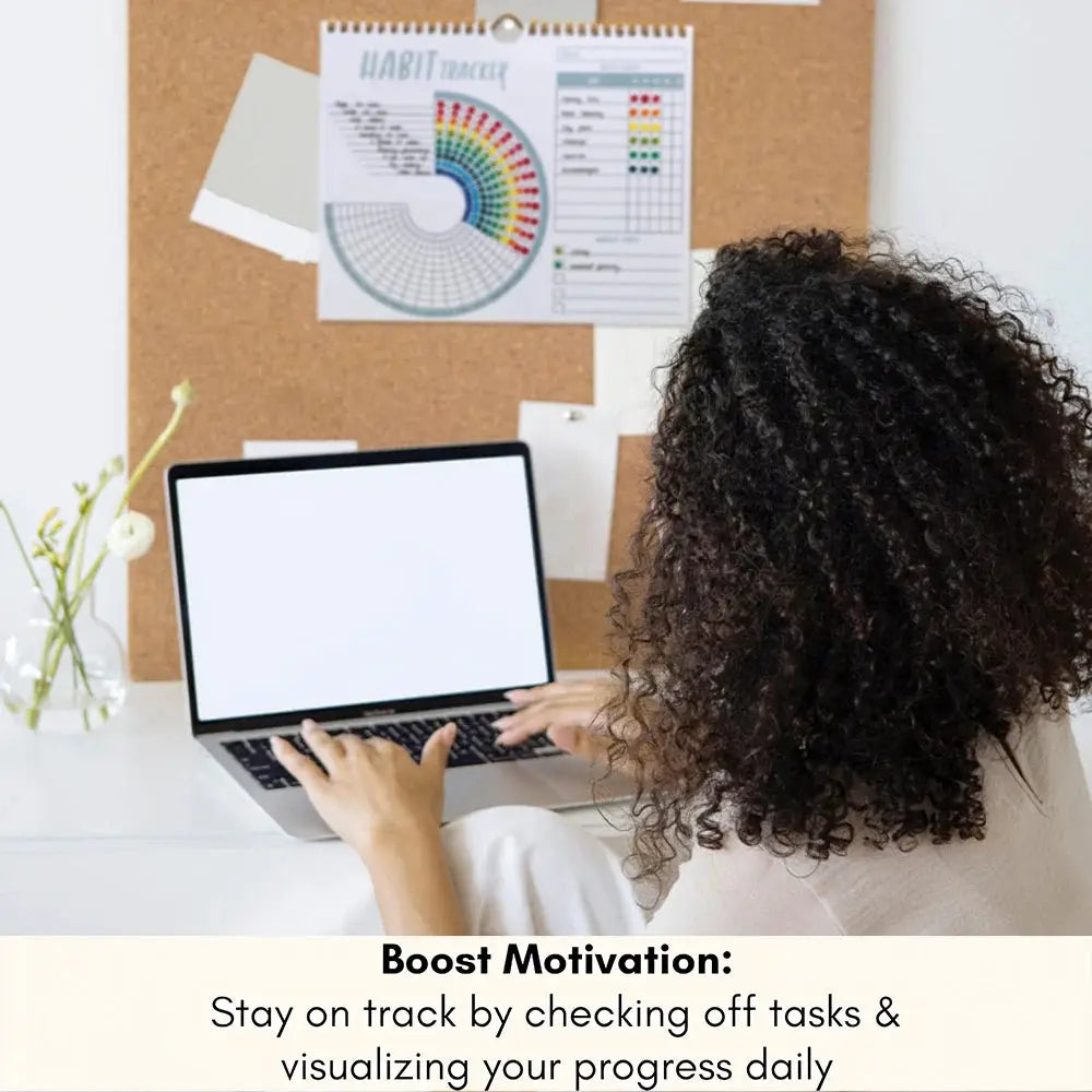 Habit Tracker Calendar Journal by Simples Market on a desk with a laptop and corkboard habit chart.
