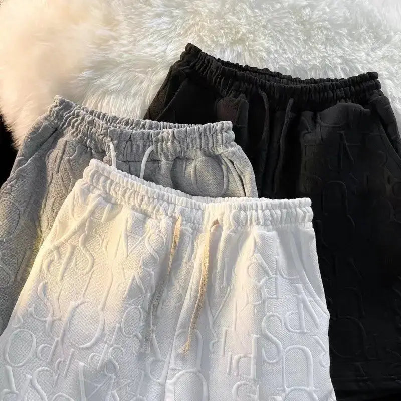 Men's waffle casual shorts, 4-pack, loose wide-leg running style in white, gray, and black.