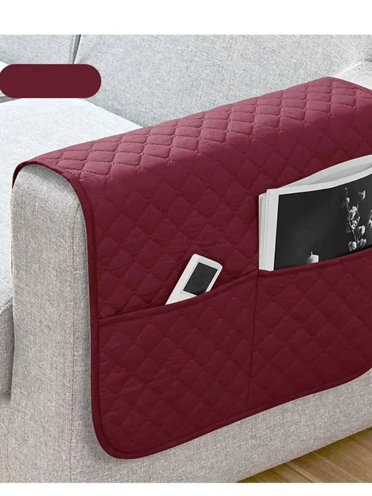 Sofa armrest cover with pockets in maroon quilted fabric; water-repellent, holds remote and magazine.