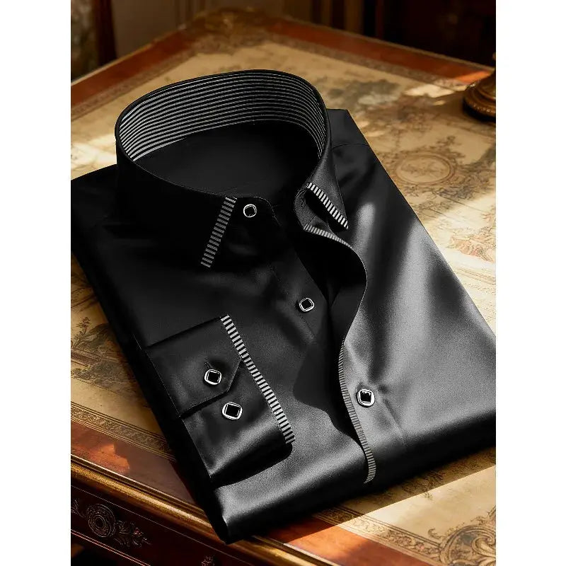 Men's black dress shirt with striped inner collar and cuffs, folded on a wooden table
