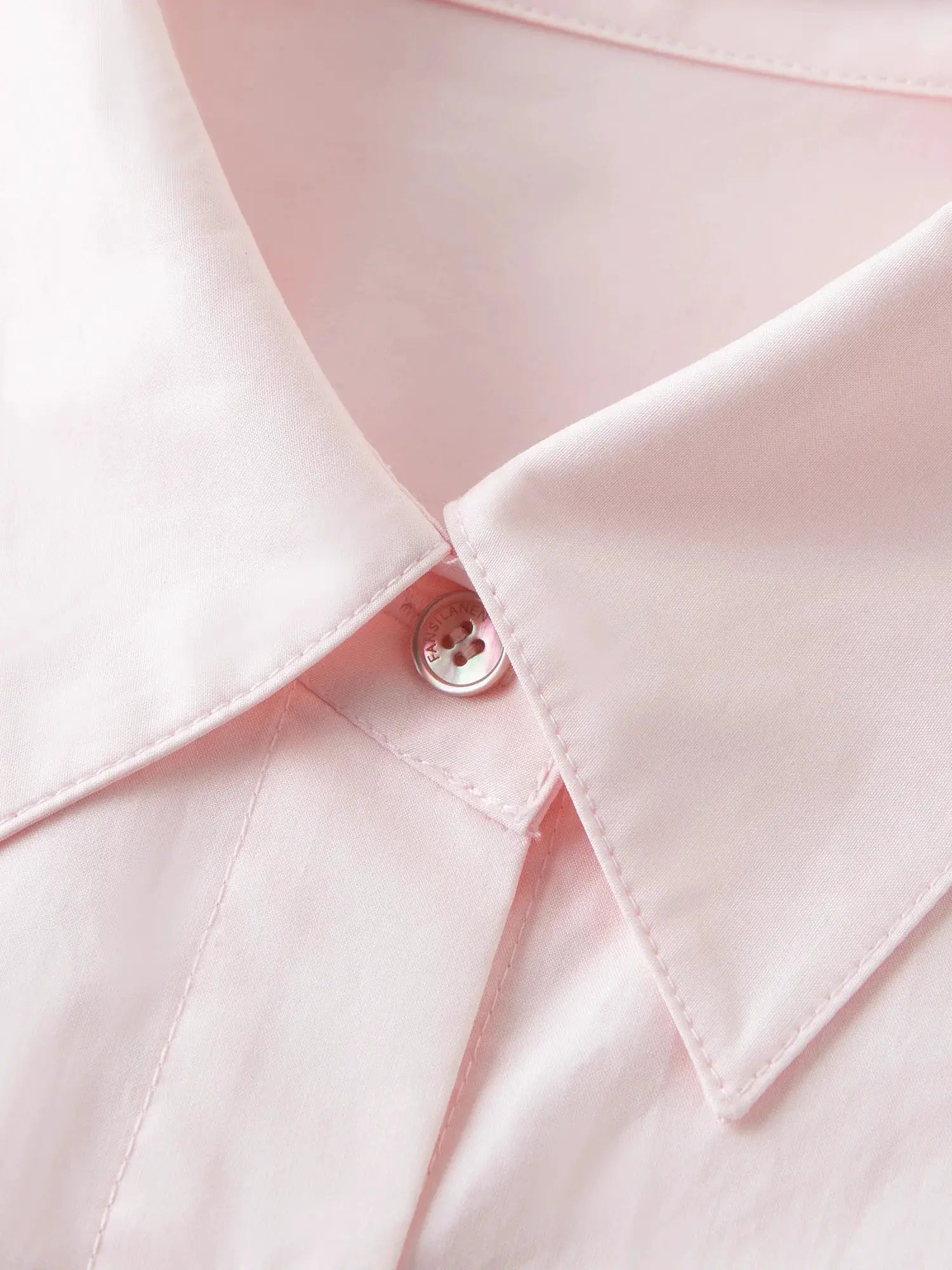 Pink cotton shirt with collar and button placket; loose-fit long-sleeve oversized blouse