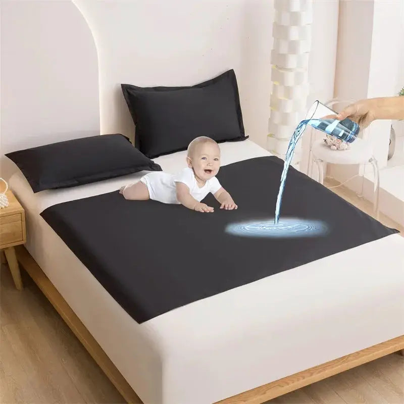 Bed flat sheet TPU waterproof mattress cover in black on a white bed; water poured onto it to show waterproof layer.