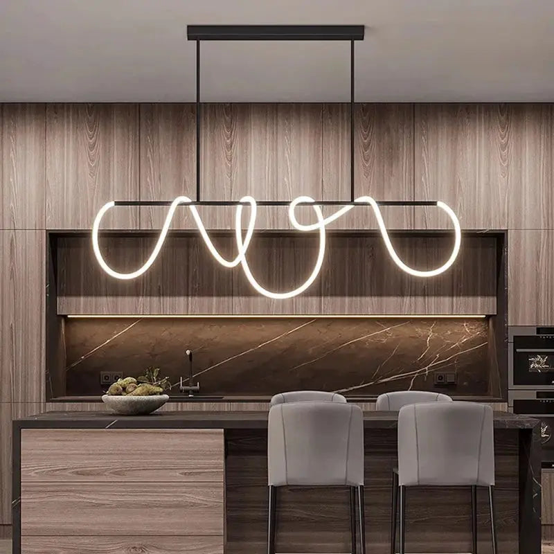 Nordic-style pendant chandelier with white LED looping light over a kitchen island in a wood and marble setting