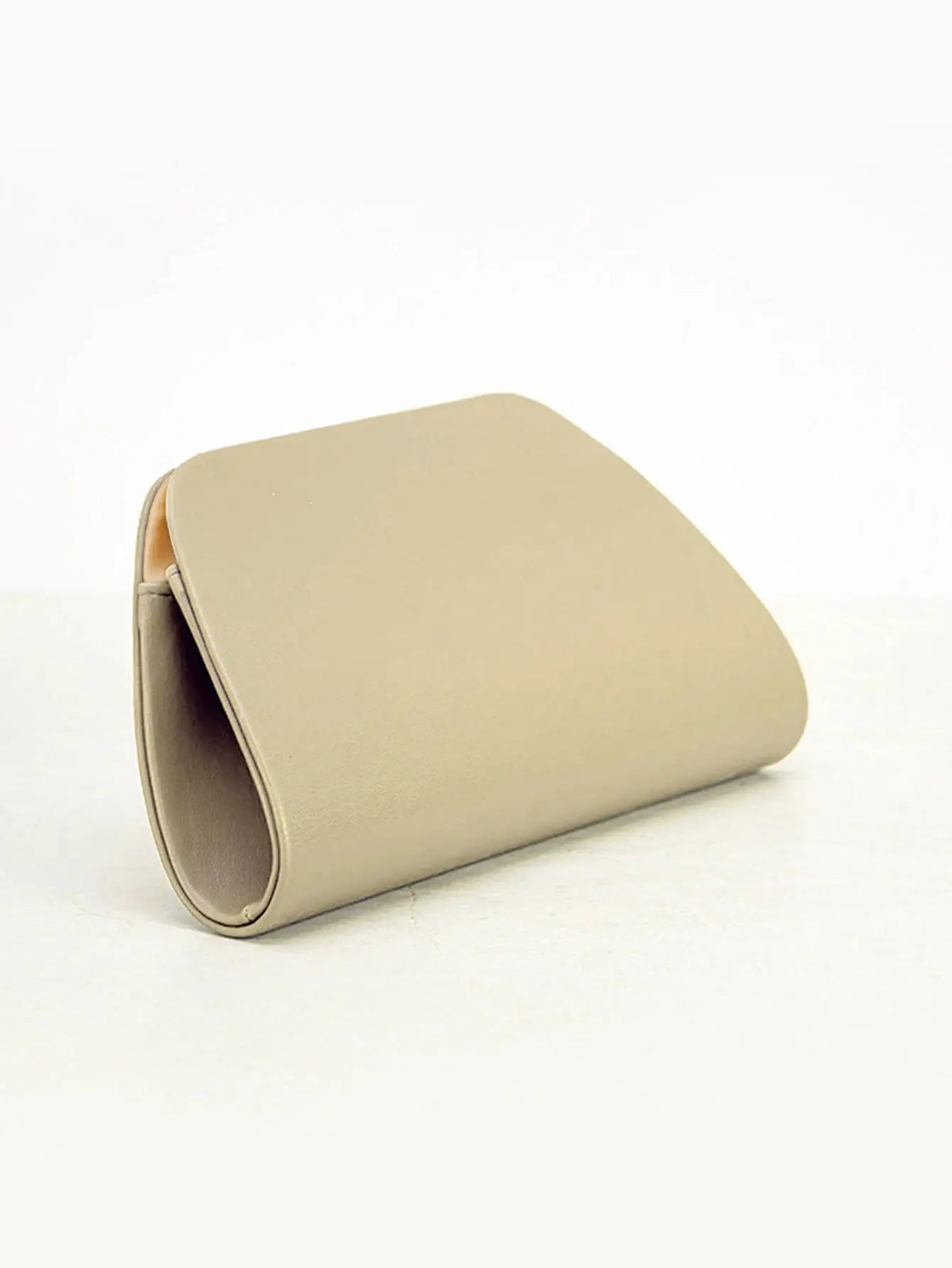 Beige box clutch handbag with curved silhouette; faux leather evening bag