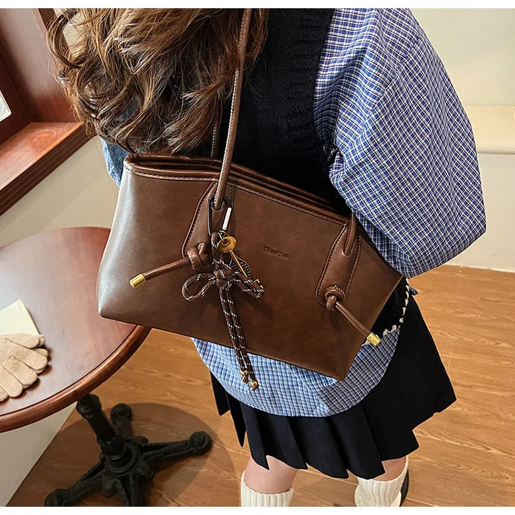 PU Leather Shoulder Bag for Women by Simples Market, brown with crossbody strap and tassel charm
