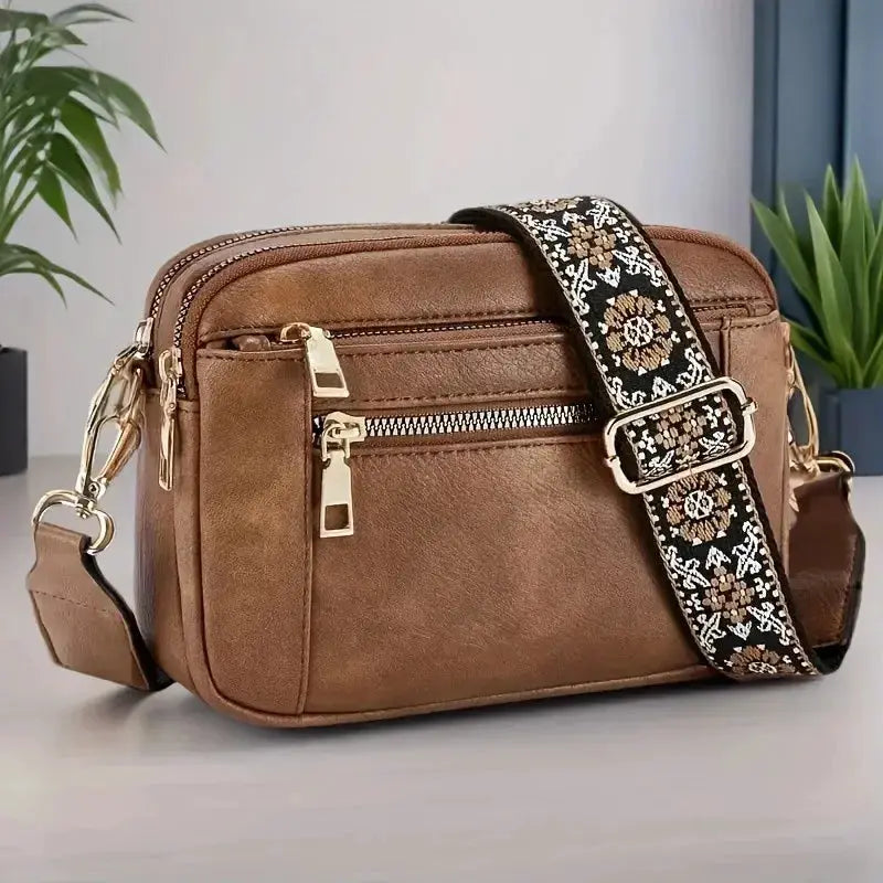 Crossbody bag Simples Market brown small square multifunctional bag with floral strap and gold zippers.
