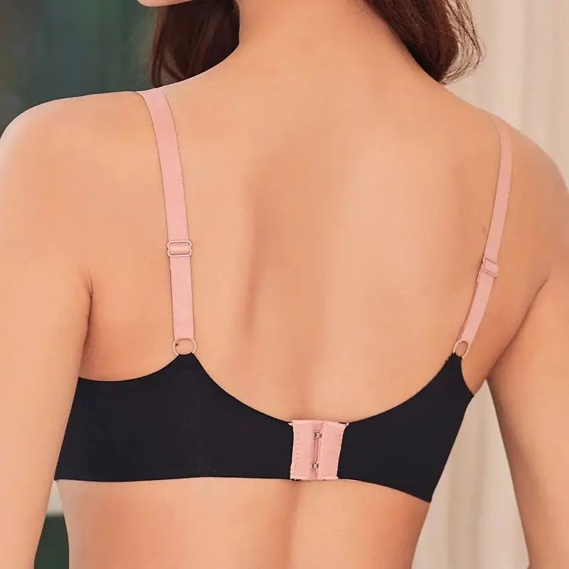 Push-up bra in black with pink adjustable straps and back clasp.