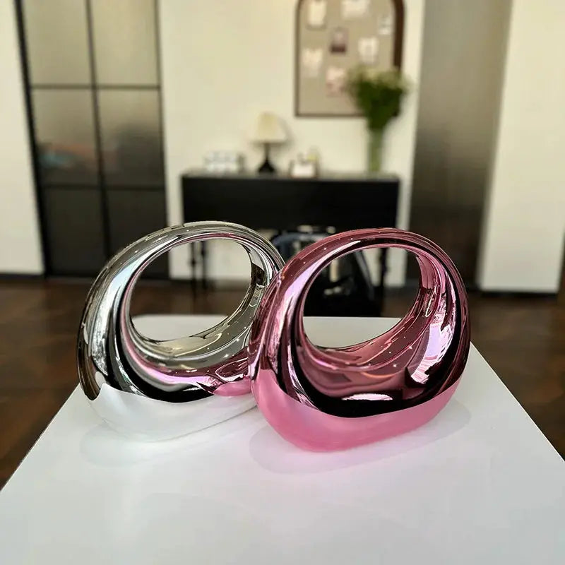 MOODS round-handle PVC wrist bags; two metallic clutches in silver and pink