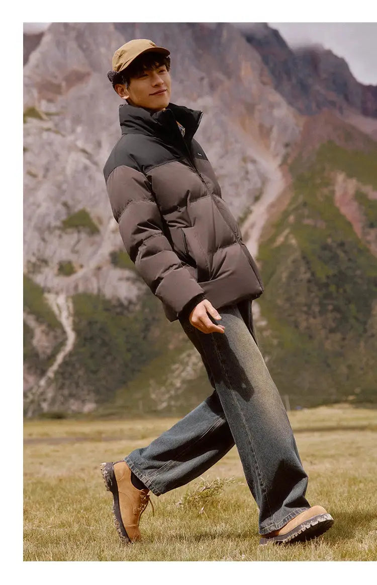 Semir down jacket, two-tone black and taupe puffer, worn by a man outdoors in mountain scenery.