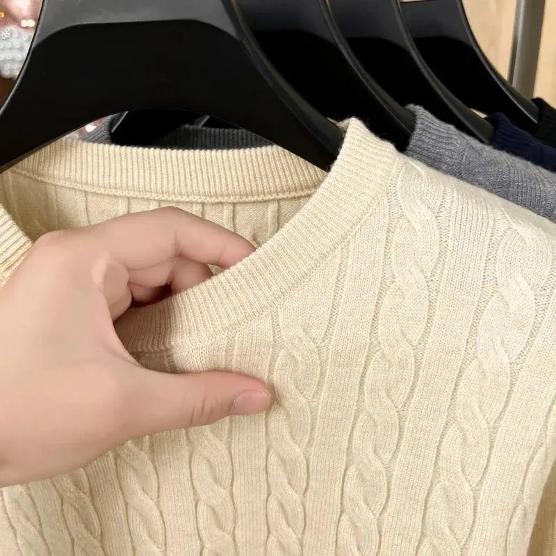 Beige cable-knit men's crewneck sweater with ribbed collar and long sleeves.