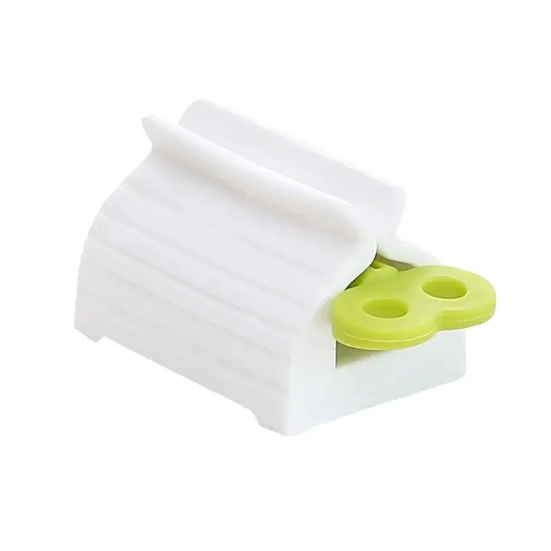 Toothpaste tube squeezer by Simples Market; white plastic body with lime-green lever for easy squeezing.