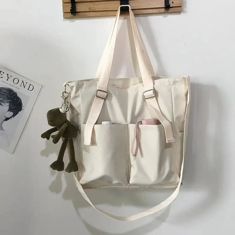Simples Market waterproof Oxford large-capacity women handbag with dual front pockets and beige color.