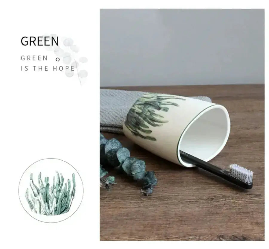 White ceramic bathroom toothbrush holder with green botanical pattern; includes 1 toothbrush.