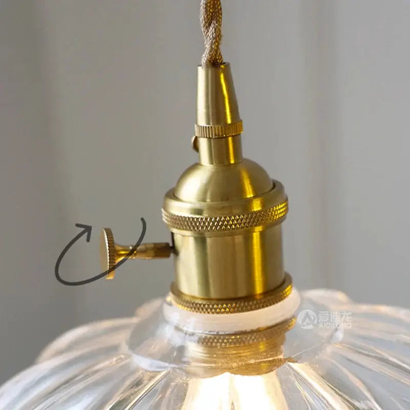 Vintage brass pendant light with clear ribbed glass shade and knurled knob.