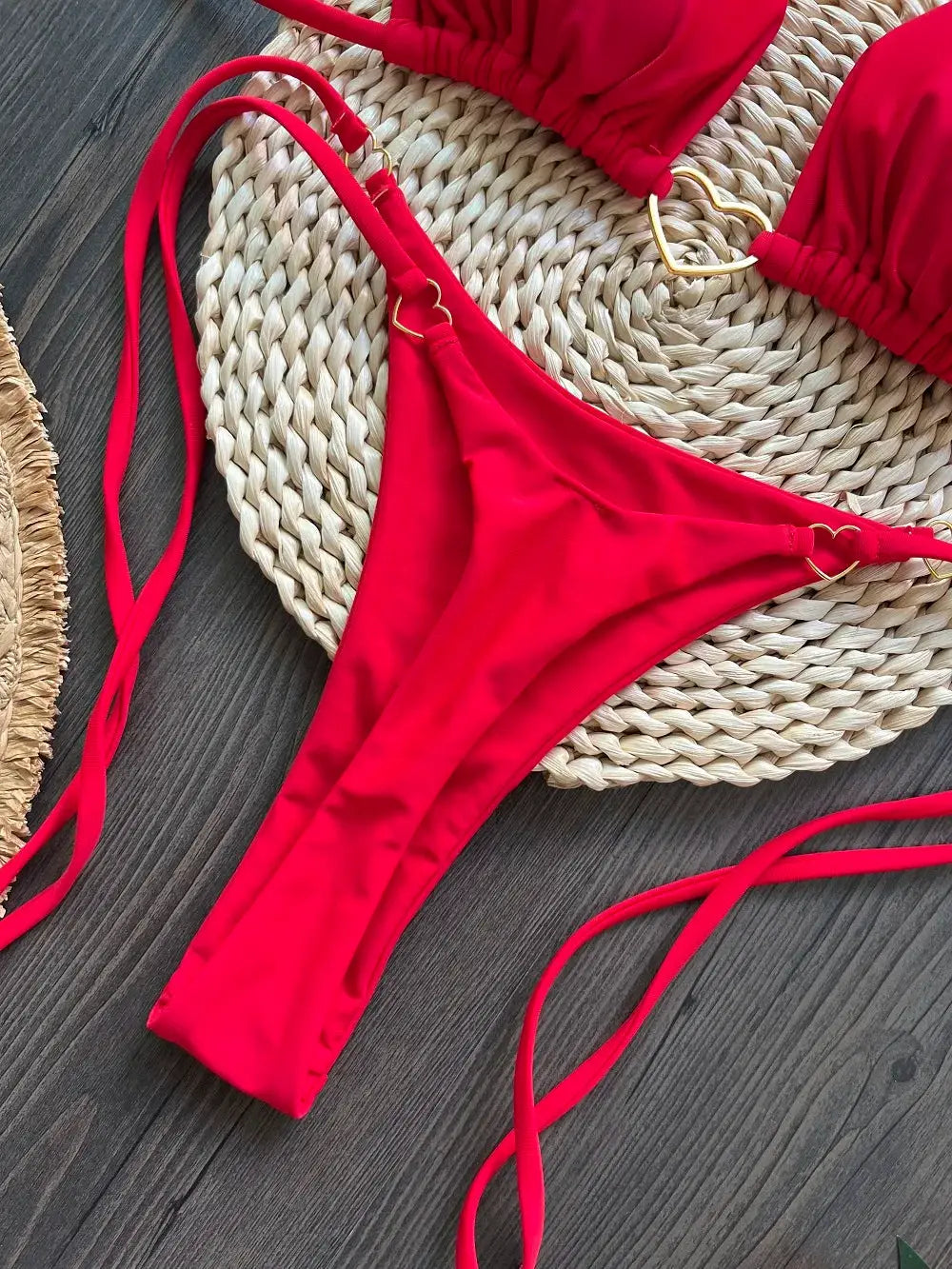 Red two-piece halter bikini set with triangle thong bottoms and gold heart ring accents