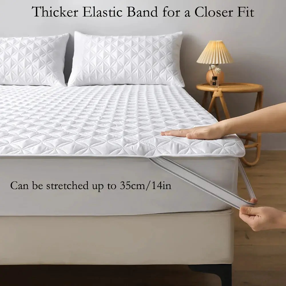 Waterproof mattress protector with elastic band, white quilted cover being stretched to fit the bed