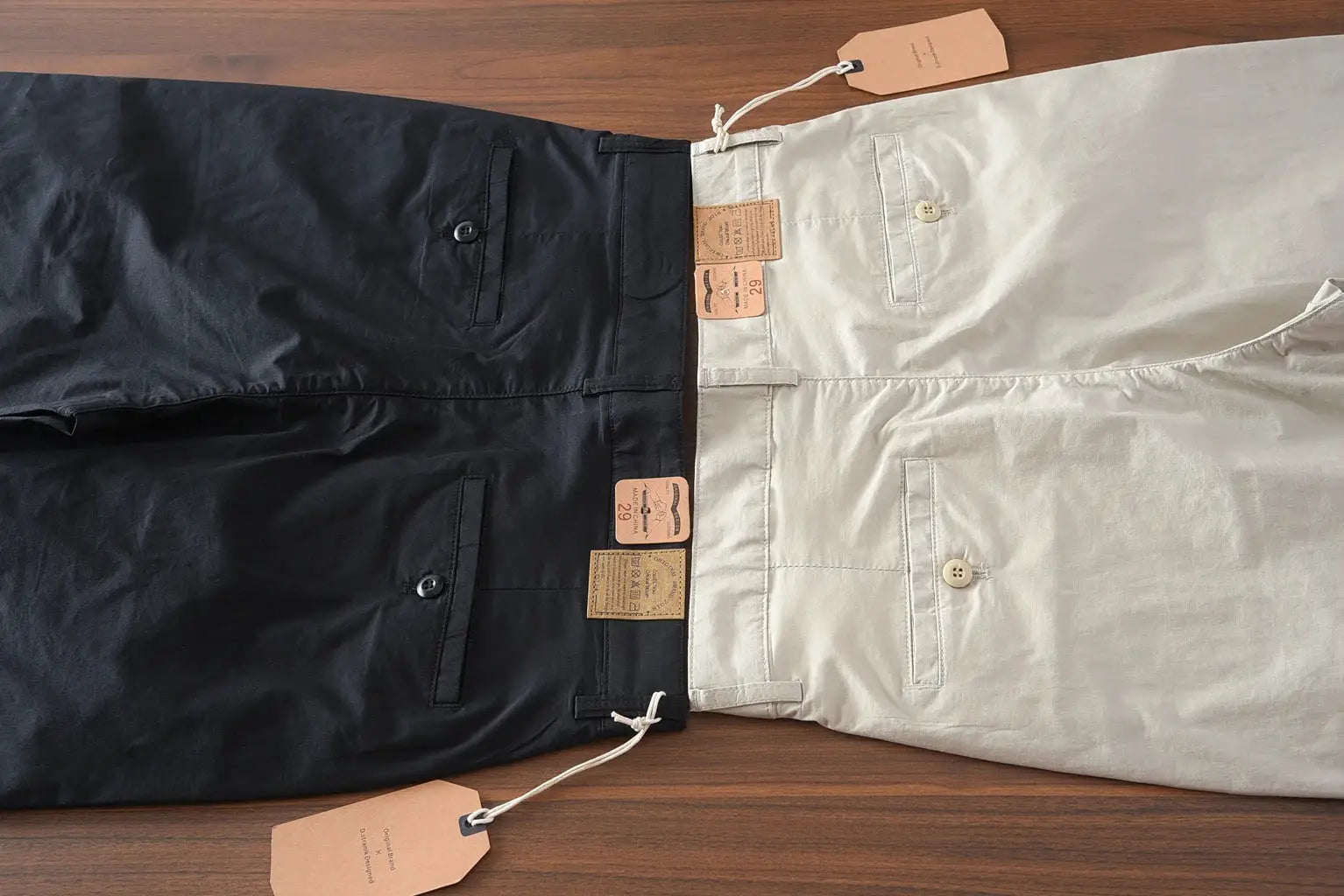 Chino pants pair in black and khaki from Simples Market with tags